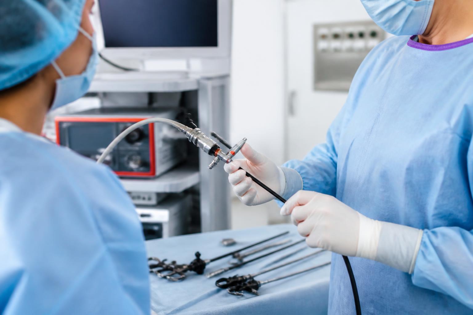 Clinical team preparing minimally invasive surgical equipment